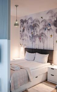 a bedroom with a bed with a mural of palm trees at Rakowicka Apartments Nearto Old Town in Krakow
