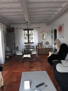 a living room with a couch and a table at Campagno chambre d hote in Mougins