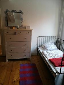 a bedroom with a bed and a dresser with a tv at Ferienwohnung Burg Lindenfels in Lindenfels