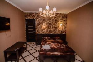 a bedroom with a bed and a chandelier at Хуторок in Smila