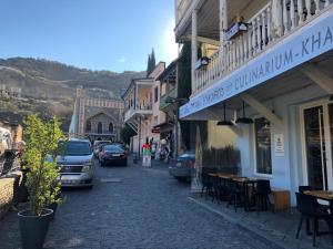 a cobblestone street with cars parked on the side of a building at Abano view apartment in Tbilisi City