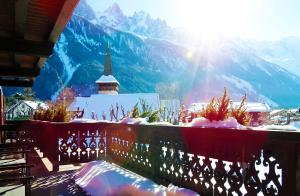 a balcony with a view of a snow covered mountain at Hotel Le Castel in Chamonix-Mont-Blanc
