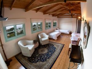 ein Wohnzimmer mit weißen Möbeln und Fenstern in der Unterkunft Casa Mare in Nymfaio