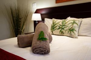 a towel animal sitting on top of a bed at Forest Lodge in St Lucia