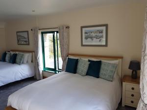 
a bedroom with a white bed and white walls at Padraicins B&B in Furbo
