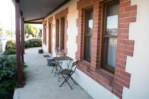 a patio with chairs and a table on the side of a building at Longreach at Port Elliot in Port Elliot