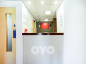 a corridor of a hospital hallway with a white wall at OYO Sunrise Hotel, A46 N Leicester in Thrussington