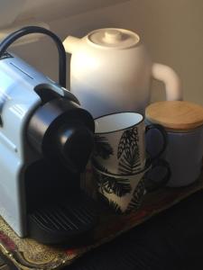 a coffee maker and a cup on a table at Brugge’s House of Friends in Bruges