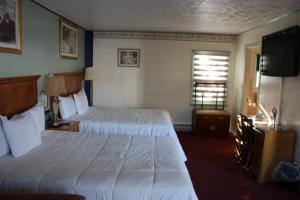 a hotel room with two beds and a television at Northside Motel - Williamstown in Williamstown