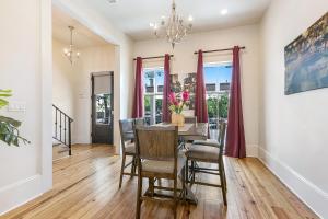 a dining room with a table and chairs at 3BR Cottage on Carondelet by Hosteeva in New Orleans