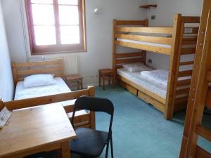 a room with two bunk beds and a table at Gite l'Aiguillette du Lauzet in Le Monêtier-les-Bains