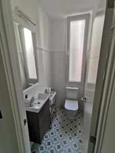 a white bathroom with a sink and a toilet at Begoña 18 Rest & Adventure in Gijón +29 photos