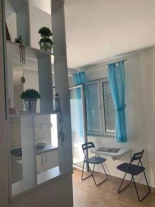 a kitchen with two chairs and a table in a room at Apartment Stella Maris in Herceg-Novi