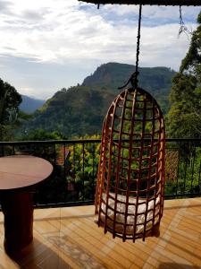 a cage filled with wine bottles on a balcony at Lucky Star Ella in Ella