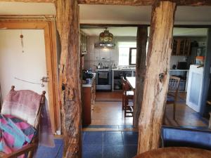a kitchen and dining room with wooden beams at Casa Rural Huillinco in Huillinco