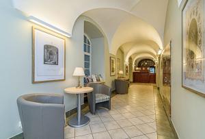 a hallway with a table and chairs in a building at Domus Maria in Vilnius