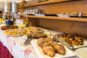 a buffet with many different types of bread and pastries at Hotel Rabay in Brenzone sul Garda +152 photos