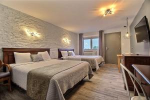 Postel nebo postele na pokoji v ubytování Hotel Motel Le Quiet