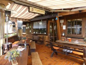 a restaurant with benches and tables in a room at Pension Holzerstube in Beerfelden