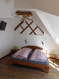 a bedroom with a bed with a ceiling fan at Ferienhaus Seeperle in Bodman-Ludwigshafen