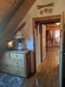 a room with a dresser with a lamp on it at Gite Du Bois De L'ours in Orcières