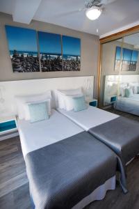 
a hotel room with two beds and a large window at Coral Compostela Beach Golf in Playa de las Americas
