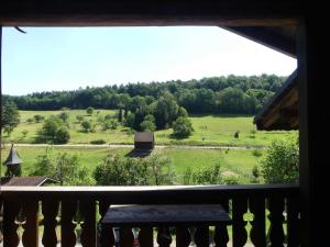 a view of a green field from a balcony at Pension Holzerstube in Beerfelden