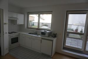 a kitchen with a sink and a microwave at Terrassentraum in Vienna