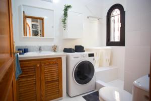 a bathroom with a washing machine and a sink at Sunshine Miami Beach in Mogán +11 photos