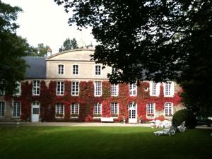 a large red brick building with white windows at Manoir Saint Hubert in Saint-Vigor-le-Grand