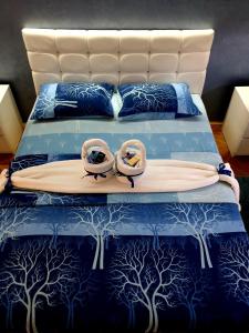 a bed with two rings on it with trees on it at Apartment Centar Exclusive Smederevo in Smederevo