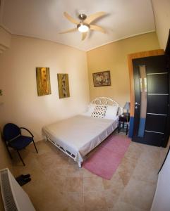 a bedroom with a bed and a ceiling fan at Luxury Villa Thea in Volos