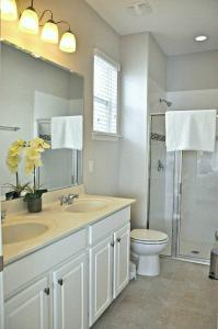 a bathroom with a sink and a toilet and a shower at 5356 Water Park Solterra Resort 5bed house - 10 minutes from Disney in Davenport