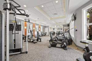 a gym with treadmills and cardio equipment in a room at 5356 Water Park Solterra Resort 5bed house - 10 minutes from Disney in Davenport