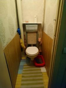 a small bathroom with a toilet in a hallway at Cozy room nearly the United Exhibition Center on the metro station Levoberejnaya. in Kyiv