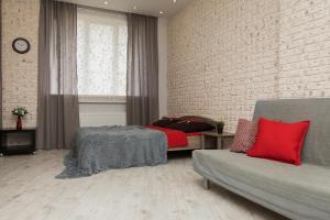 a living room with a couch and a brick wall at Apartments on Krasnozvezdnaya st.31 in Nizhny Novgorod