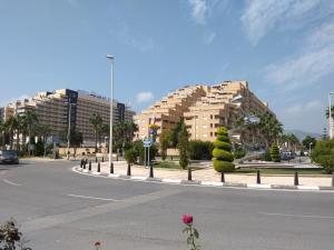 an empty street with two large buildings in a city at ACV Segunda Linea in Oropesa del Mar