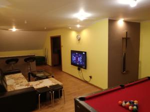 a living room with a pool table and a tv at privát femamki in Ličartovce
