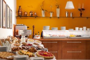 
a kitchen filled with lots of different types of pastries at BEST WESTERN Titian Inn Hotel Venice Airport in Tessera
