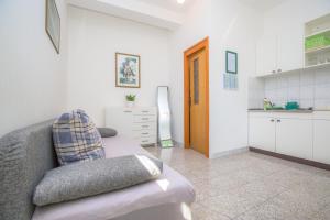a living room with a couch and a kitchen at Apartmani Jadranka in Primošten +40 photos
