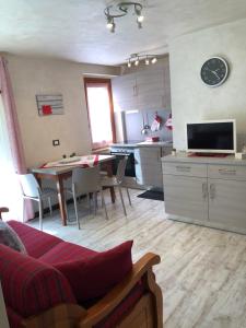 a living room with a kitchen and a dining room at Candide in Pré-Saint-Didier