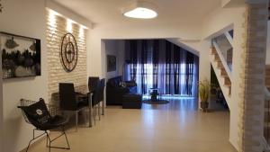 a living room with a staircase and a living room with a table at Amazing in Haifa