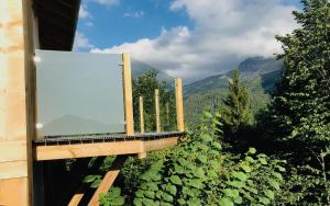 a glass balcony with a view of the mountains at Mazot Hirondelle in Morzine