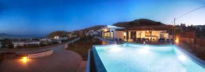 a hotel with a swimming pool at night at Luxury Villa Panorama in vlicha