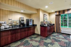 a hotel room with a cash register and a barber shop at Cobblestone Inn & Suites - Vinton, IA in Vinton