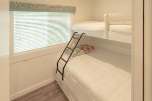 a bedroom with two bunk beds and a window at Sun Outdoors Old Orchard Beach Downtown in Old Orchard Beach +9 photos