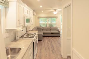 a kitchen and living room with a couch at Sun Outdoors Old Orchard Beach Downtown in Old Orchard Beach