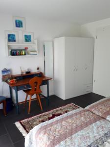 a bedroom with a desk and a bed and a table at Bad Säckingen - Sie werden sich hier wohlfühlen in Bad Säckingen