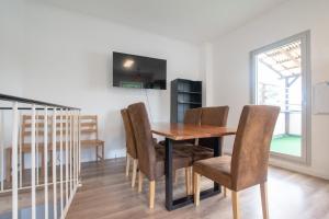 a dining room with a wooden table and chairs at Spacious House in Düsseldorf