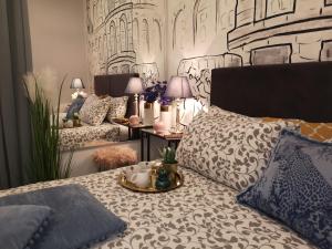 a bedroom with a bed with a tray on it at Arena Design Apartments with FREE Private Parking and with a terrace in Pula